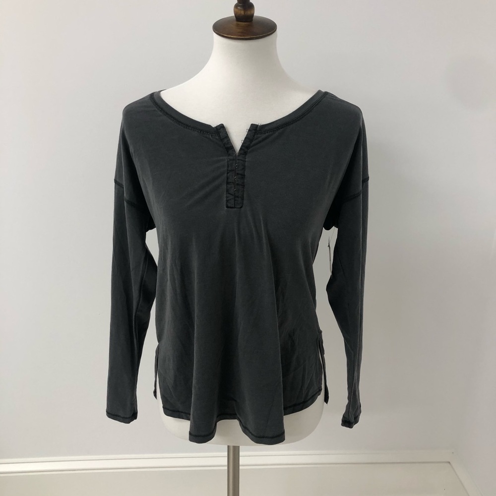A gray long sleeve with hooks on the top